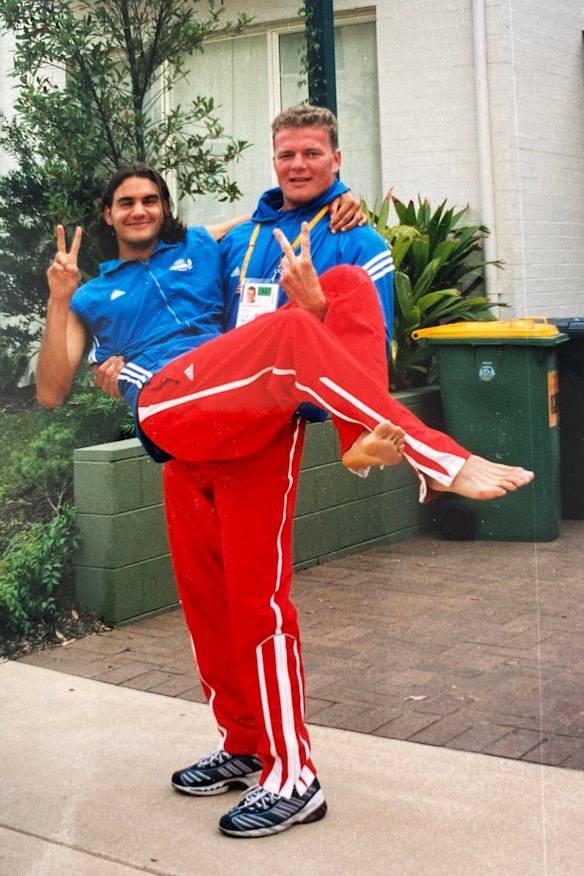 Getting carried away: Roger Federer with Swiss wrestler Urs Bürgler.