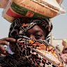 A Sudanese woman displaced from El Fasher collects food aid at El Afadh refugee camp.
