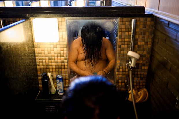 A man washes himself at an onsen in Yokohama, Kanagawa prefecture.