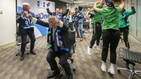 Australian officials and players celebrate in Sydney as FIFA announced Australia and New Zealand would host the 2023 Women's World Cup.