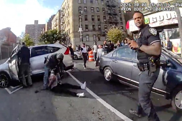 In this image taken from police-worn body camera video released the New York City Police Department (NYPD), law enforcement personnel tend to a Oscar Belgal, 28, a Dominican man who was shot by Federal immigration officers,, as he drove his car with a five-year-old boy inside.