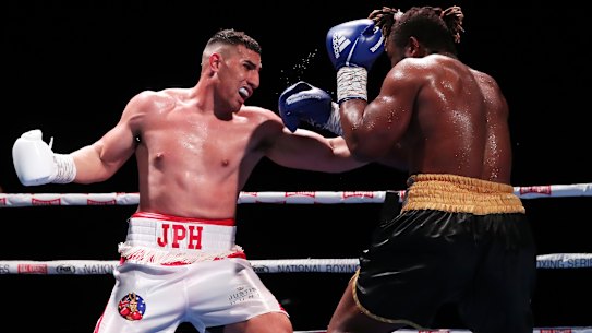 Christian Tsoye (right) defends himself as Justis Huni lets fly on Wednesday.