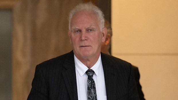 Former AFL umpire coach Frank Kalayzich (right) departs a Fair Work Commission hearing