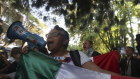 People protest outside the Ecuadorian embassy in Mexico City.