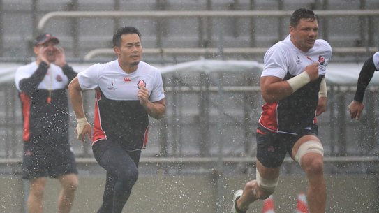 Rain or shine: Japan endure the big wet for their captain's run.