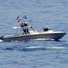 FILE - An Iranian Revolutionary Guard vessel watches an American warship in the Strait of Hormuz, May 19, 2023. (AP Photo/Jon Gambrell, File)