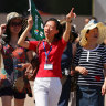 A guide points out the sights of Sydney to a group of Chinese tourists.