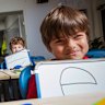 Port Melbourne Primary School prep students Brooklyn, Chloe, Felix and Gonzalo use an explicit instruction approach to learning to read with principal Tom Cain.