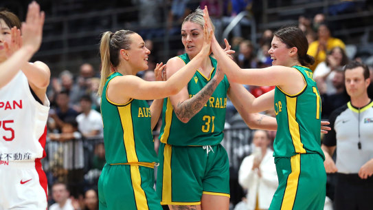 Tess Madgen, Cayla George and Jade Melbourne celebrate the Opals’ win over Japan.