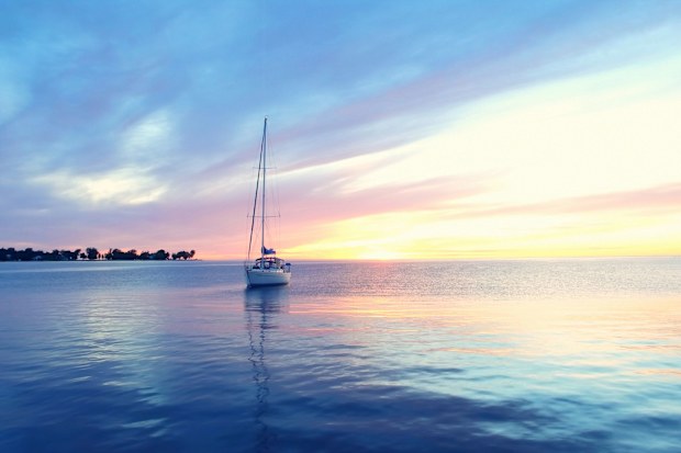 A sailboat drifts through the bucolic bay at Egg Harbor in Door Peninsula, which is rich in state and county parks.