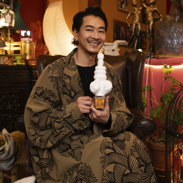 Moody Ko, managing director of niche fragrance boutique The Garden of Spring in Sydney’s Haymarket. He holds a perfume bottle with a custom topper made by one of his employees, Tah Chantarat, a scientist turned artist.