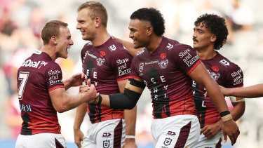 Daly Cherry-Evans and Haumole Olakau’ata  are front and centre of celebrations after Tom Trbojevic’s try.