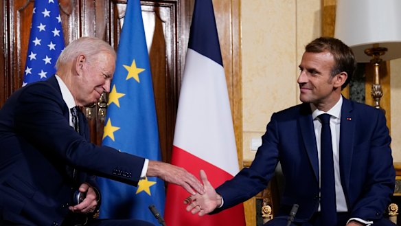 US President Joe Biden and French President Emmanuel Macron shake hands ahead of a meeting in Rome.