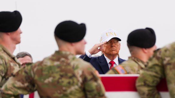 President Donald Trump salutes as an Army carry team moves a flag-draped transfer case with the remains of Sgt. Declan Coady, 20, of West Des Moines, Iowa, who was killed in a drone strike at a command centre in Kuwait.