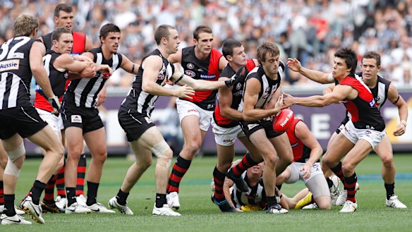Collingwood defender Alan Toovey finds himself at the front of a queue of Magpies and Bombers.