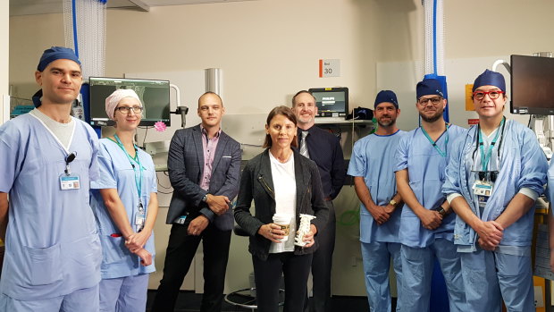Frecklington, flanked by some of the extensive team of doctors, nurses and technicians who performed her marathon surgery. 