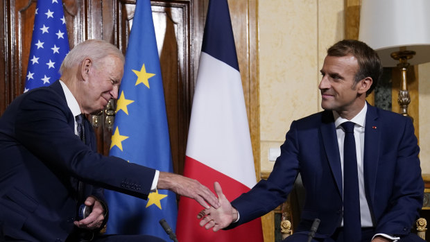 US President Joe Biden and French President Emmanuel Macron shake hands ahead of a meeting in Rome.