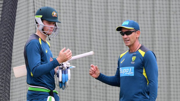 Handscomb talks with coach Justin Langer in the nets.