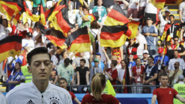 Mesut Ozil listens to the national anthem before Germany's World Cup match with South Korea.