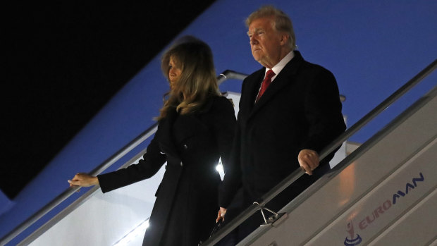 President Donald Trump and first lady Melania Trump alight from Air Force One, after arriving at Orly airport near Paris.