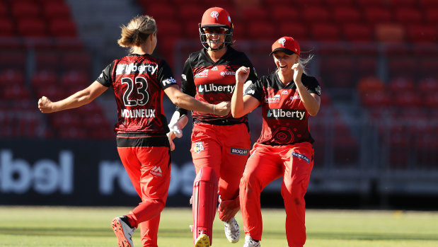Renegades bowler Sophie Molineux celebrates with Josie Dooley (left) and Amy Yates after the win.