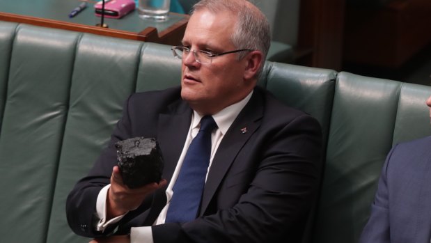 Prime Minister Scott Morrison with a lump of coal during question time at Parliament House in Canberra last year.
