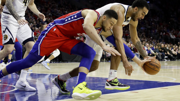 Philadelphia 76ers' Ben Simmons competes for the ball with Denver Nuggets' Trey Lyles.