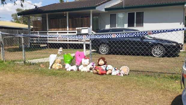 The Logan community left flowers and toys in honour of the two girls who died. 