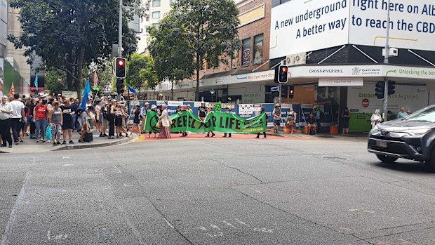 Activists march and chant on Thursday in the latest Extinction Rebellion protest in Brisbane's CBD.