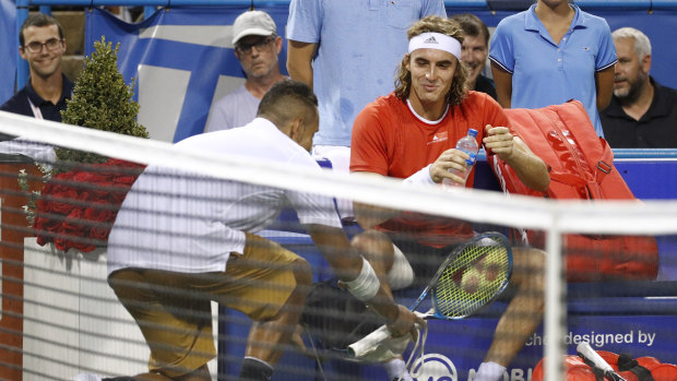 The comedian: Nick Kyrgios delivers a pair of shoes to Stefanos Tsitsipas in a light-hearted exchange during their semi-final in Washington.