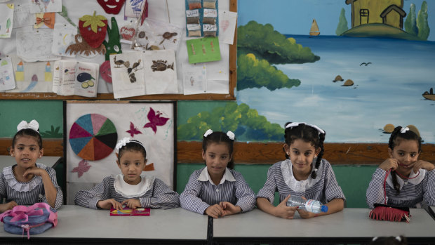 Girls sit inside a classroom at an UNRWA school during the first day of a new school year in Gaza City.