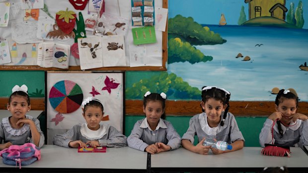 Girls sit inside a classroom at an UNRWA school during the first day of a new school year in Gaza City.