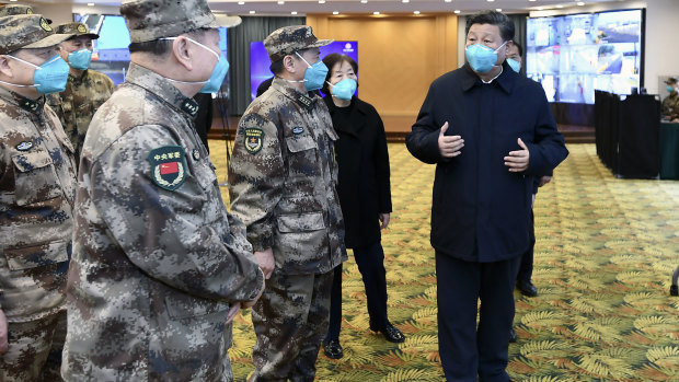 Chinese President Xi Jinping, right, is briefed in Wuhan on Tuesday.