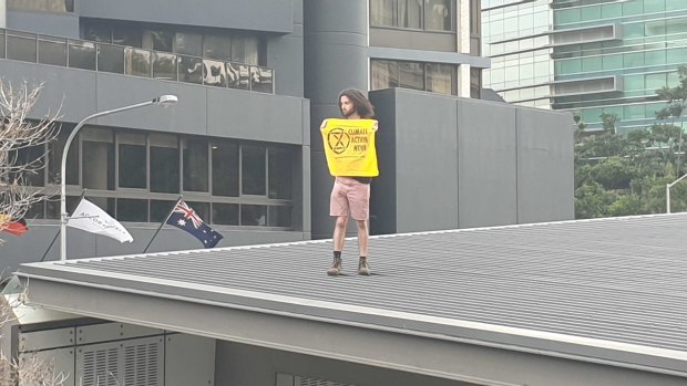 An Extinction Rebellion protester climbed on top of the King George Square bus station building about 4.30pm. He was arrested half an hour later.