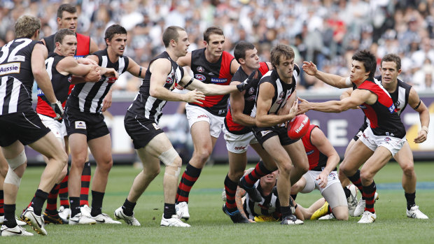 Collingwood defender Alan Toovey finds himself at the front of a queue of Magpies and Bombers.