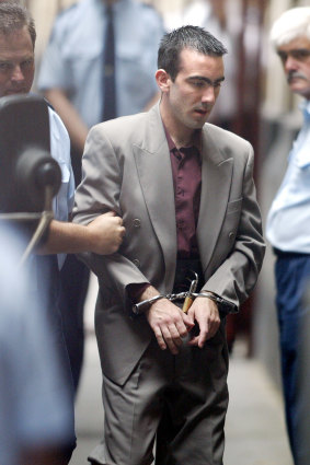 Jason Roberts is led into court during his murder trial in December 2002.