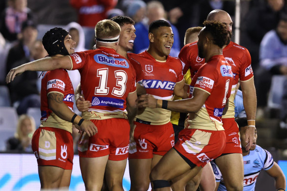 Dolphins players celebrate a try during the win over Cronulla.