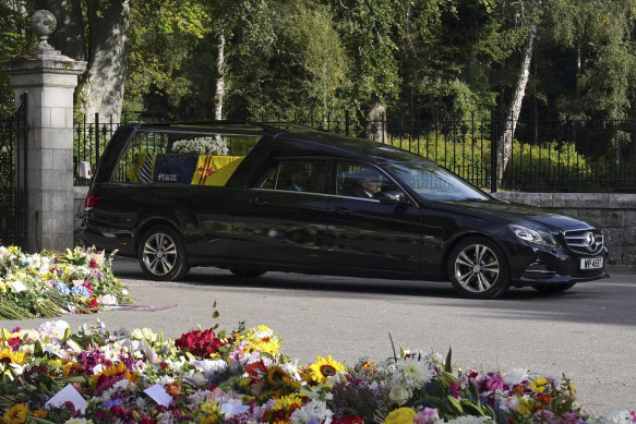 The hearse carrying the coffin of Queen Elizabeth II, draped with the royal standard of Scotland leaves Balmoral as it begins its journey to Edinburgh on September 11, 2022.