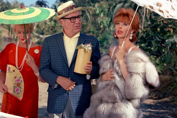 The rich and oblivious Thurston Howell III with Lovey Howell, left,  and Ginger on the television series Gilligan’s Island. 