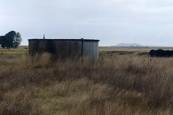 Where once stood the heart of a community - a hall and tennis courts - only a water tank remains, the volcanic upthrust of Mount Rouse in the distance.