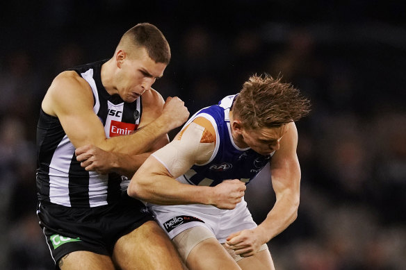The bump: Collingwood's Brayden Sier and North Melbourne's Jack Ziebell clash.