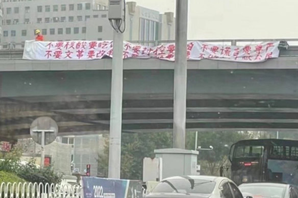 Peng Lifa with his banners on the Beijing overpass last week.