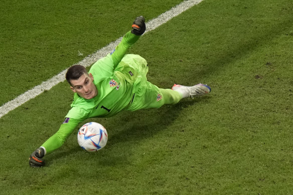 Croatia’s goalkeeper Dominik Livakovic saves a penalty kick by Japan’s Kaoru Mitoma.