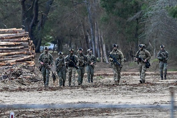 Police officers during the Manhunt in Porpunkah on Monday.