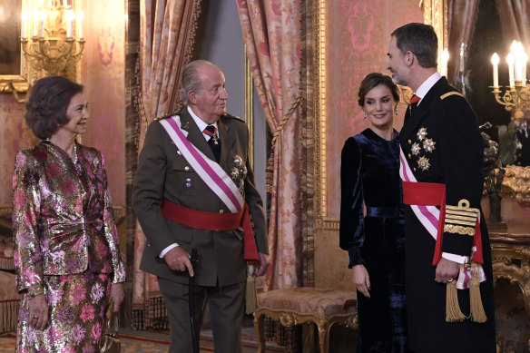 From left, former Spanish queen Sofia and king Juan Carlos, speak to his son King Felipe, right, and his wife Queen Letizia in 2018.