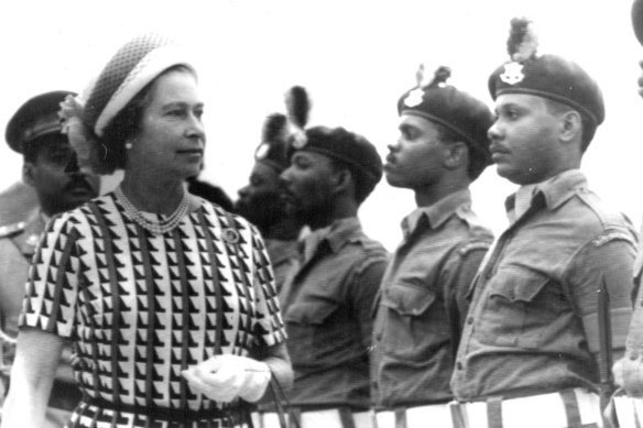 Queen Elizabeth inspects a guard of honour as she arrives in Bridgetown, Barbados on the final visit during her Silver Jubilee tour in 1977.