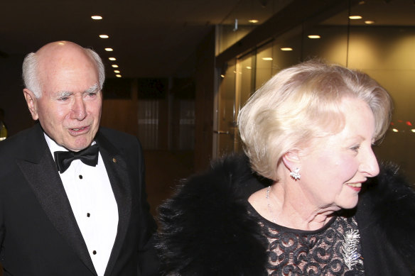 John and Janette Howard arrive at the former prime minister’s 80th birthday party at the Australian Club in 2019.
