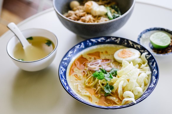 Ohn no khao swe coconut noodles in coconut chicken broth with spiced chicken, crispy noodles, boiled egg, coriander and fresh lime.