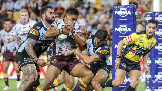 Brute force: Joe Ofahengaue powers over the line for the Broncos at Suncorp Stadium.