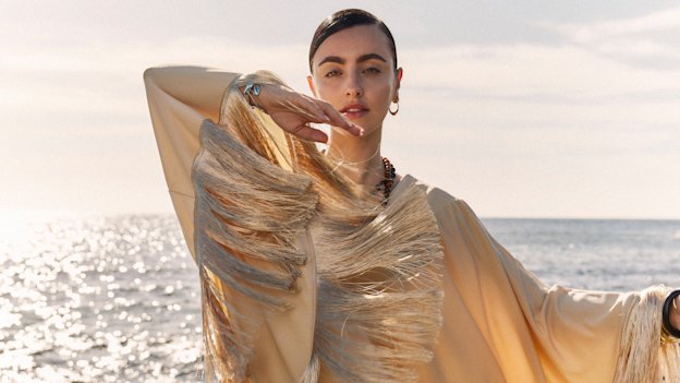 BeBe wears By Malene Birger “Colandra” dress, Jan Logan necklace and rings, Dinosaur 
Designs bangles.